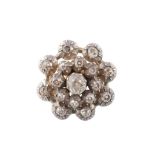 A diamond cluster ring, the circular openwork panel set throughout with old cut diamonds in pinched