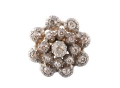 A diamond cluster ring, the circular openwork panel set throughout with old cut diamonds in pinched
