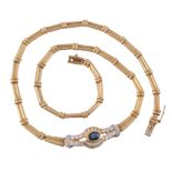 A sapphire and diamond necklace, composed of articulated polished reeded links, to the central