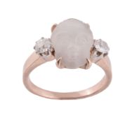 A late Victorian carved moonstone and diamond ring, the moonstone carved as a cherub's face, in a