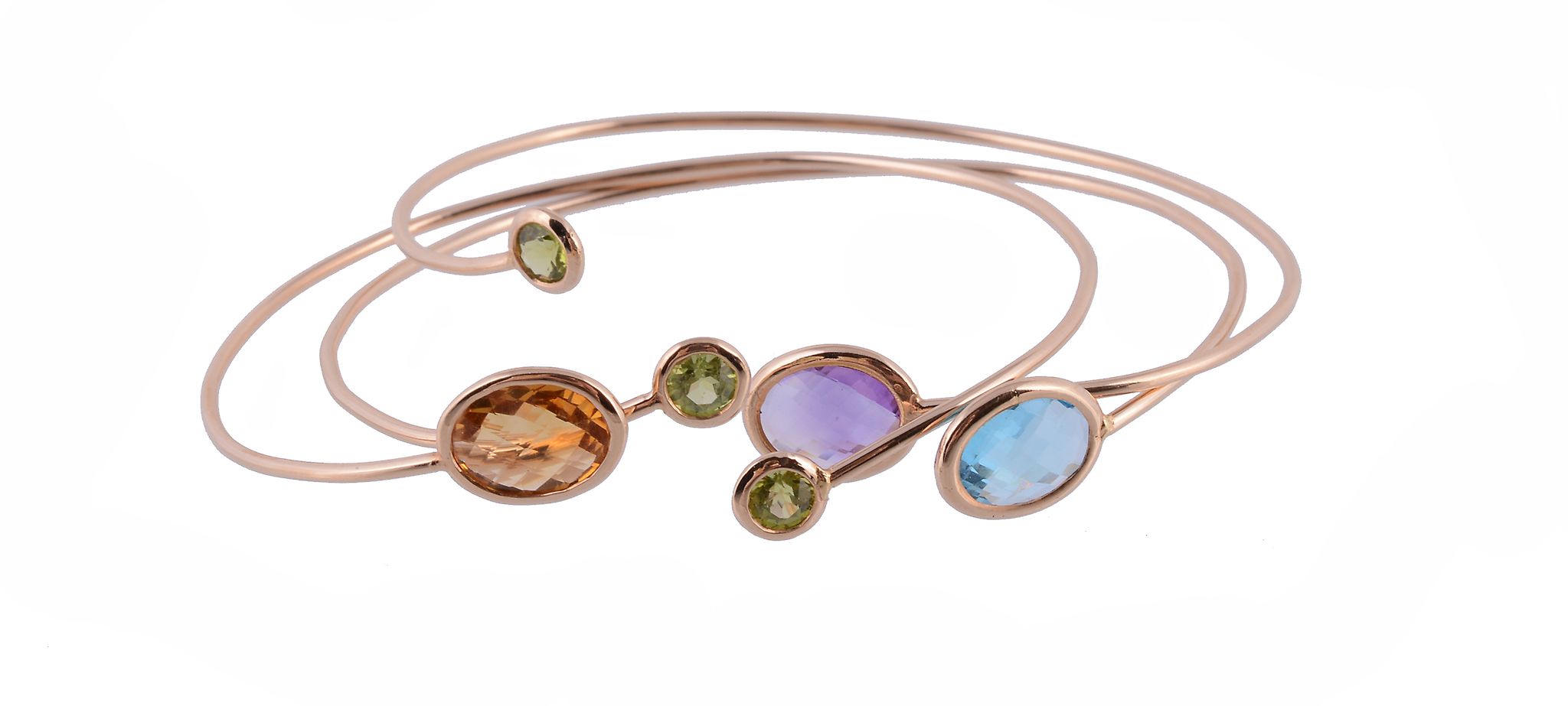 Three gem set bangles, each bangle set with different gemstones to the terminals, including: