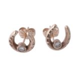 A pair of diamond set horseshoe earrings, designed as a horseshoe, each one set with a brilliant
