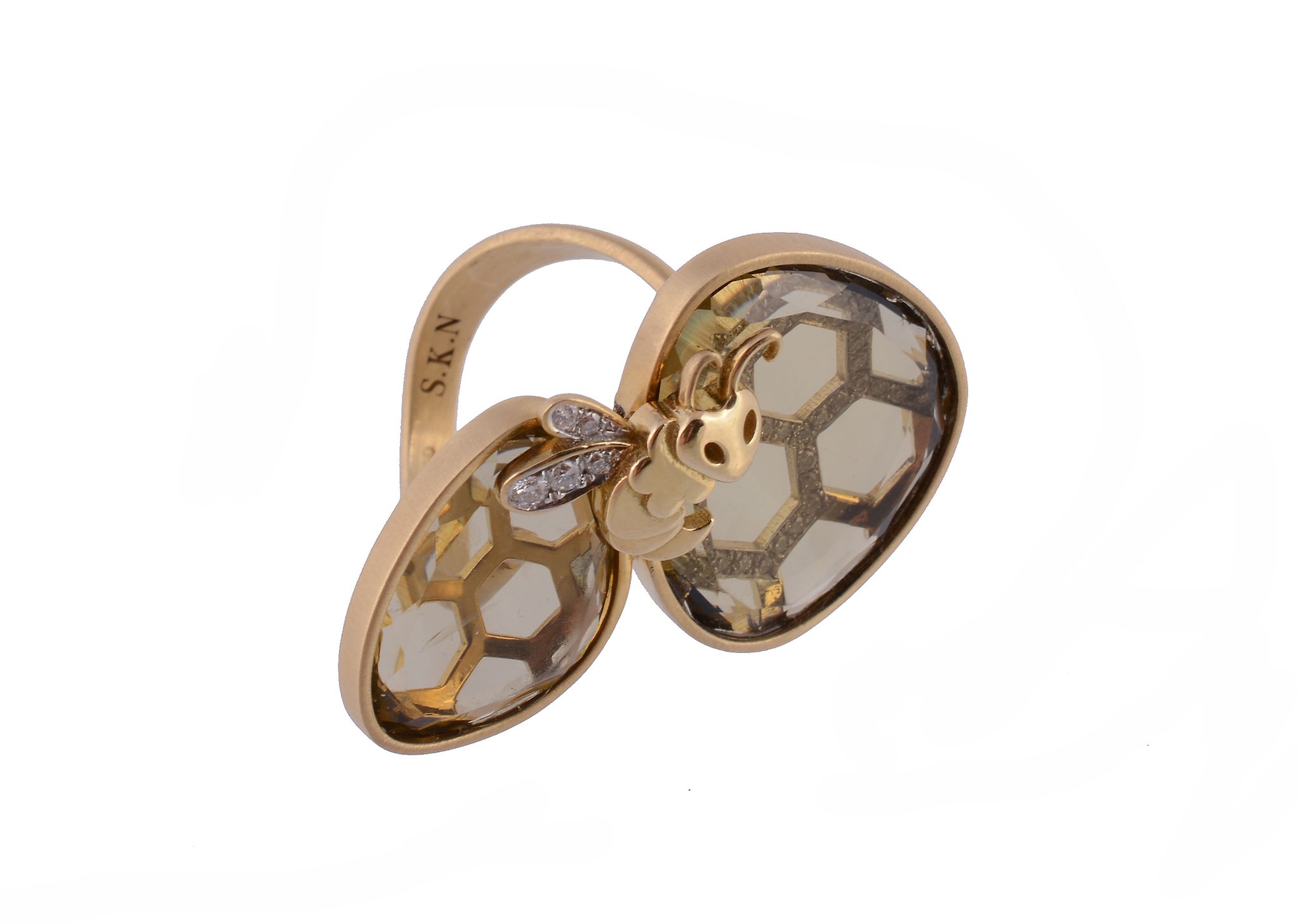 A citrine and diamond bee ring, composed of two panels of citrine with a honeycomb pattern to the