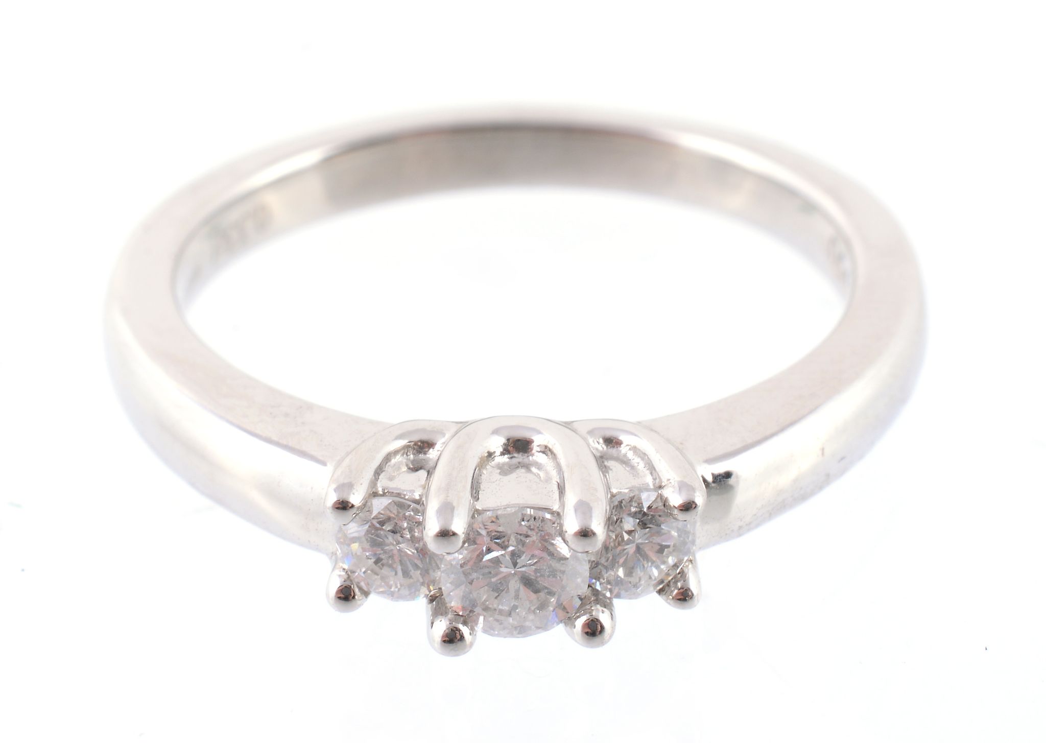 A three stone diamond ring, set with three brilliant cut diamonds to a claw setting, approximately,