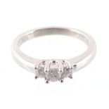 A three stone diamond ring, set with three brilliant cut diamonds to a claw setting, approximately,