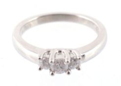A three stone diamond ring, set with three brilliant cut diamonds to a claw setting, approximately,