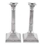 A pair of silver Corinthian column candlesticks by Goldsmiths & Silversmiths Co. Ltd., London 1927,