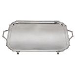 A silver twin handled tray by Mappin & Webb, Sheffield 1928, rectangular with inset curved angles,