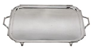 A silver twin handled tray by Mappin & Webb, Sheffield 1928, rectangular with inset curved angles,