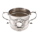 A Queen Anne silver porringer by Nathaniel Lock, London 1704, Britannia standard, with leaf-capped