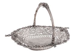An Edwardian silver shaped oval basket by Mappin & Webb, London 1909, the swing handle cast and