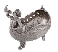 A German silver small basket by Storck & Sinsheimer, Hanau (1874-1926), cast with a half figure of