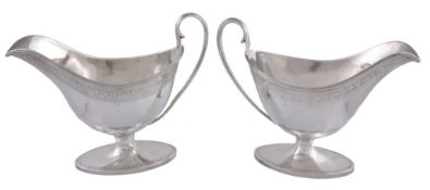 A George III silver oval pedestal sauce boat by James Young, London 1790, with a moulded high loop