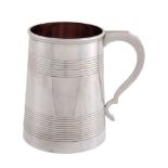 A Victorian silver tapered mug by Robert Harper, London 1859, with a double scroll handle, two