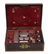 A George III travelling toilet case with matched silver mounted fittings, engraved with a crest
