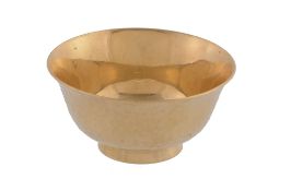 A Japanese gold coloured sake cup, stamped marks, 20th century, the bowl exterior hammered, on a