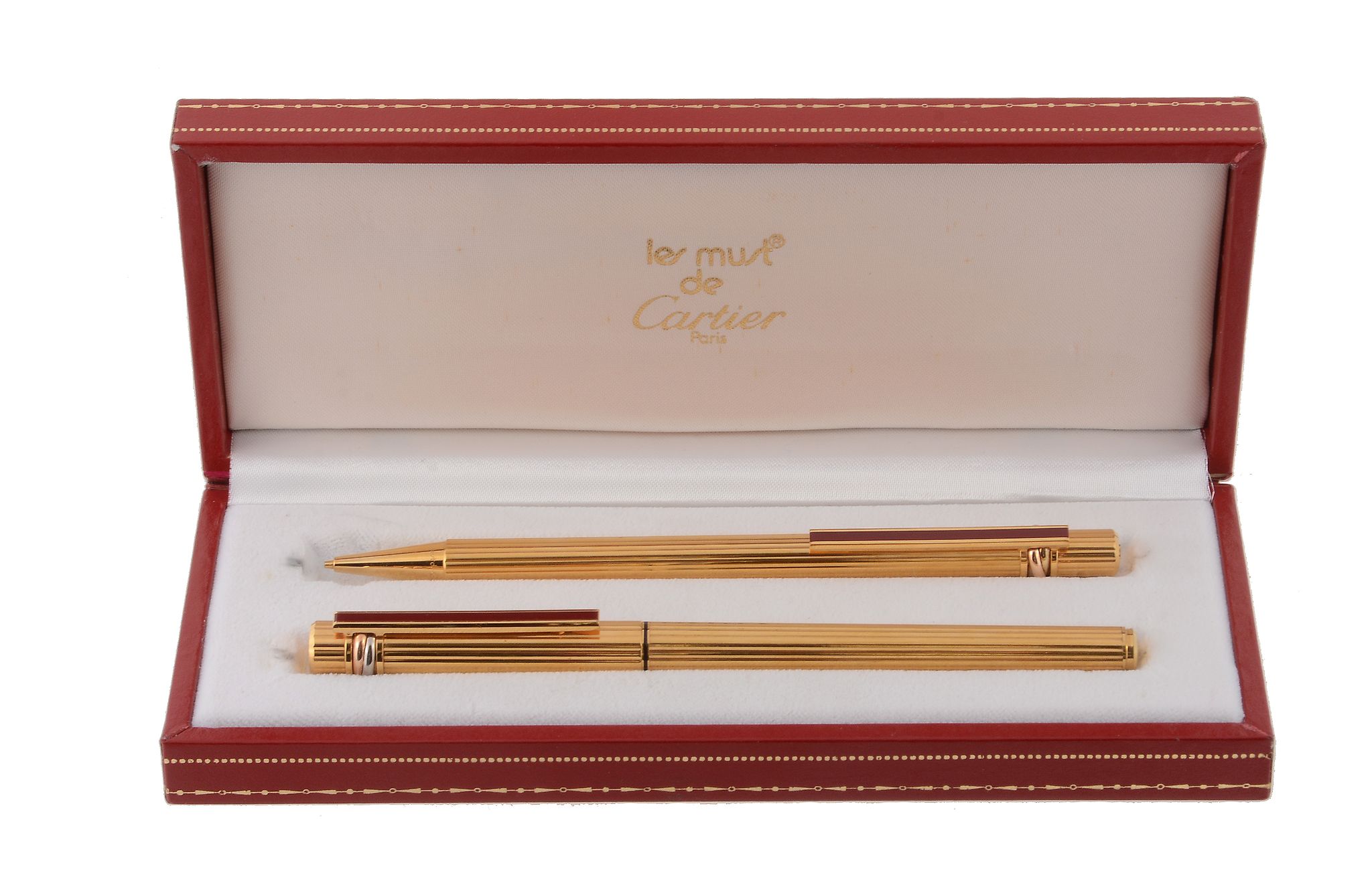 Cartier, Les Must de Cartier, a ballpoint pen and a pencil set,   both with ridged detail and a