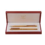 Cartier, Les Must de Cartier, a ballpoint pen and a pencil set,   both with ridged detail and a