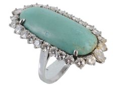 A turquoise and diamond cluster ring, the oval turquoise panel within a surround of brilliant cut
