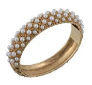 A cultured pearl set bangle, the bangle with applied lattice work rope twist decoration, the front