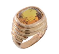 A citrine dress ring, the cushion cut citrine within a reeded polished setting, the shank with