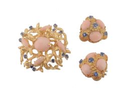 A pair of coral and sapphire ear clips, the textured triangular panels set with three claw set oval