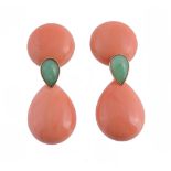 A pair of coral and jadeite earrings, the pear shaped polished corals suspended below a circular