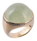 A green quartz and diamond ring, the round cabochon quartz within a brilliant pave set surround,