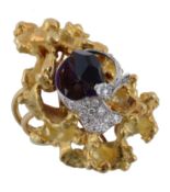 An amethyst and diamond dress ring, the crystal shaped amethyst encircled by a brilliant cut