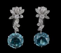 A pair of blue zircon and diamond earpendents, the round cut zircons suspended from brilliant cut