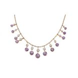 An Edwardian amethyst and aquamarine fringe necklace, circa 1910, the graduating knife edge bar