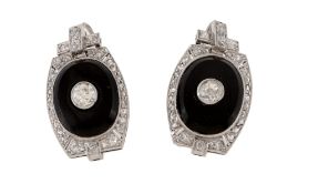 A pair of onyx and diamond earrings, the oval shaped onyx panels centrally set with an old cut