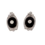 A pair of onyx and diamond earrings, the oval shaped onyx panels centrally set with an old cut