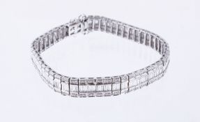 A diamond line bracelet, the articulated panels with brilliant cut diamonds centred with baguette