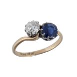 A diamond and sapphire crossover ring, set with an old cut diamond, estimated to weigh 0.65 carats,