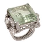 A green beryl and diamond dress ring, the square shaped green beryl in a four claw setting with a