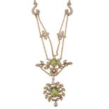 An Edwardian peridot and half pearl necklace, circa 1910, the oval shaped peridot in a cut down