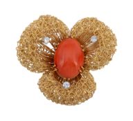 A coral and diamond flower head brooch , the three lobed wirework flower head centred with an oval