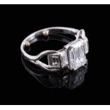 A diamond ring, the central emerald cut diamond weighing 1.70 carats, above graduated step cut