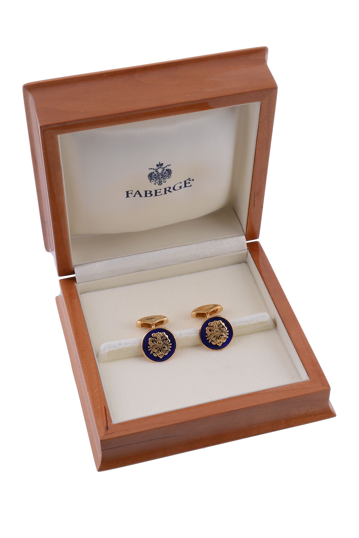 A pair of enamel cufflinks by Faberge, the circular panels with applied Imperial Eagles on a blue