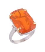 A fire opal ring, the rectangular shaped fire opal in a four claw setting, stamped with Italian