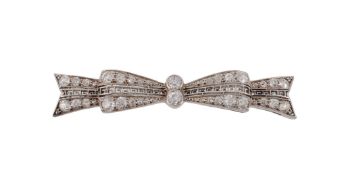 An Art Deco diamond set bow brooch , circa 1920, the bow with a central pierced Greek key design,