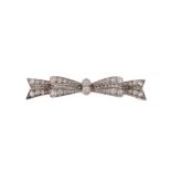 An Art Deco diamond set bow brooch , circa 1920, the bow with a central pierced Greek key design,