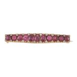 A late 19th century French ruby and diamond bar brooch, circa 1890, the tapered panel set with