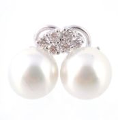 A pair of diamond and cultured pearl set earrings, the white cultured pearls, measuring 12mm