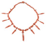 A 19th Century coral drop necklace, circa 1860, composed of coral links carved with fruiting vine