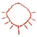 A 19th Century coral drop necklace, circa 1860, composed of coral links carved with fruiting vine