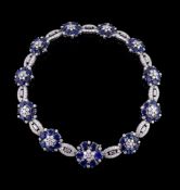 A sapphire and diamond collar, the necklace composed of graduated flower head clusters set with