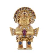 A 1970's gem set Inca figure brooch by Graff, the figure with a fringed skirt and a sapphire,