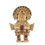 A 1970's gem set Inca figure brooch by Graff, the figure with a fringed skirt and a sapphire,